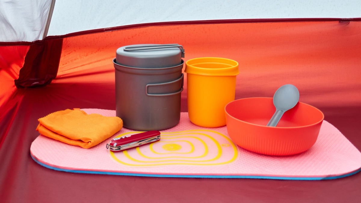 Camping essentials for beginner with a backpack and a camp stove