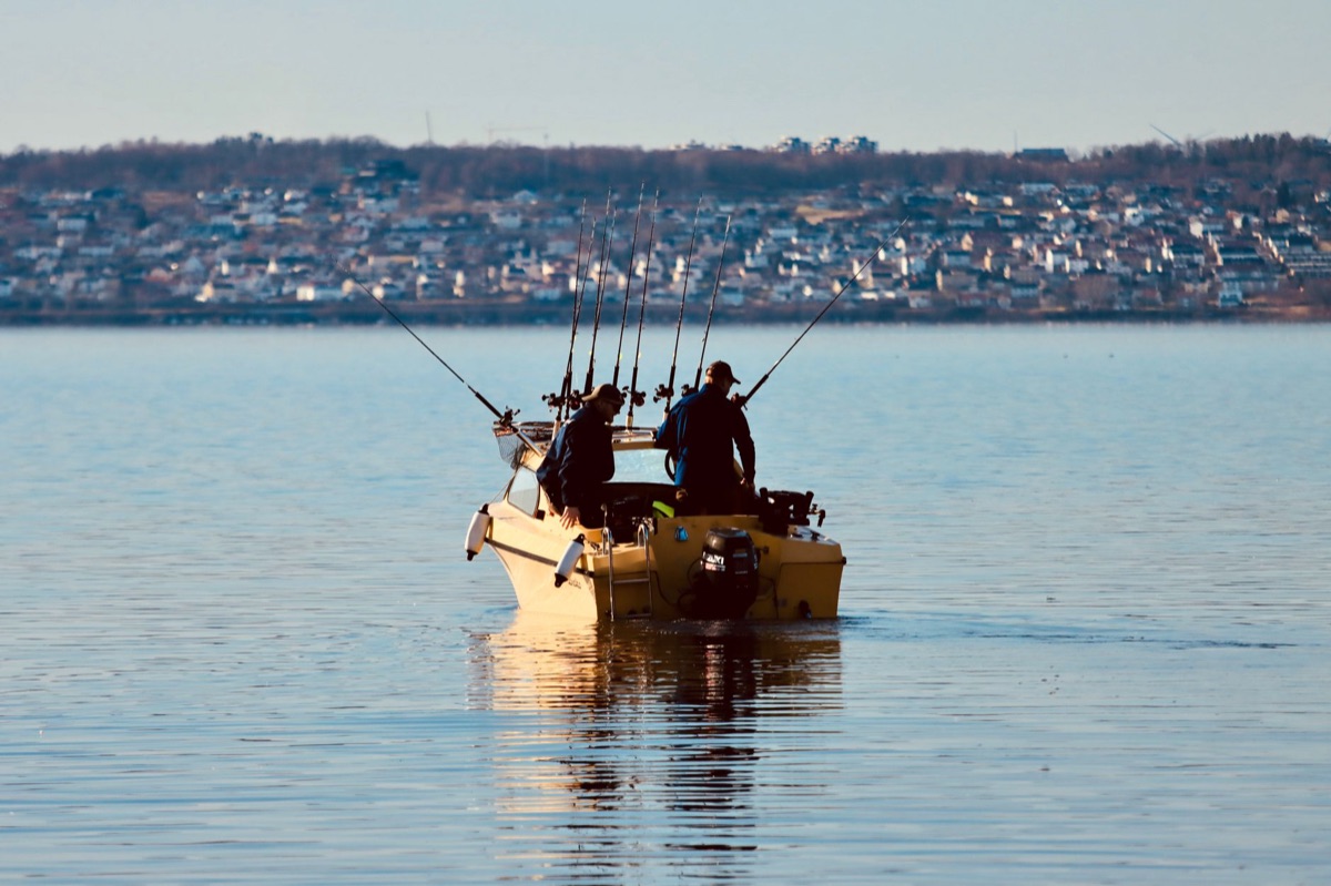 Fishing boat with angler casting line