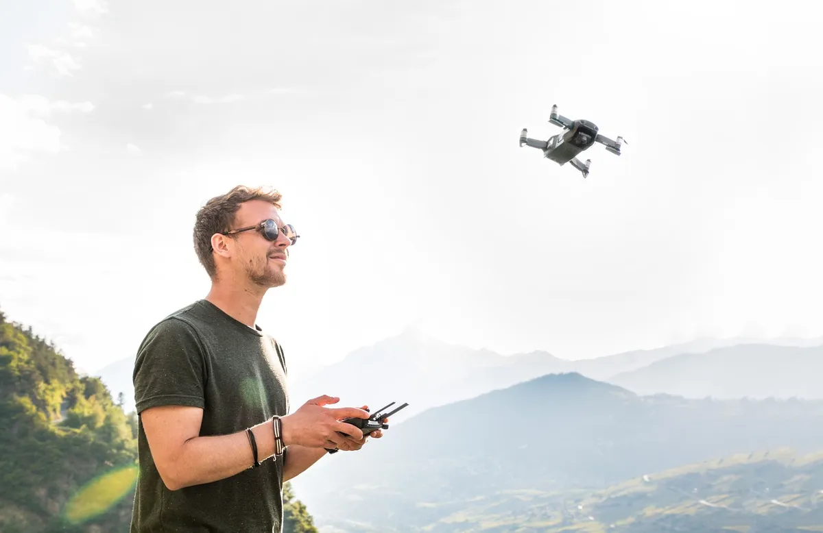 drone, man, drone pilot, copter, quadrocopter, remotely controlled, flying camera, flying object, young man, hobby, photographer, aerial photographs, mountains,